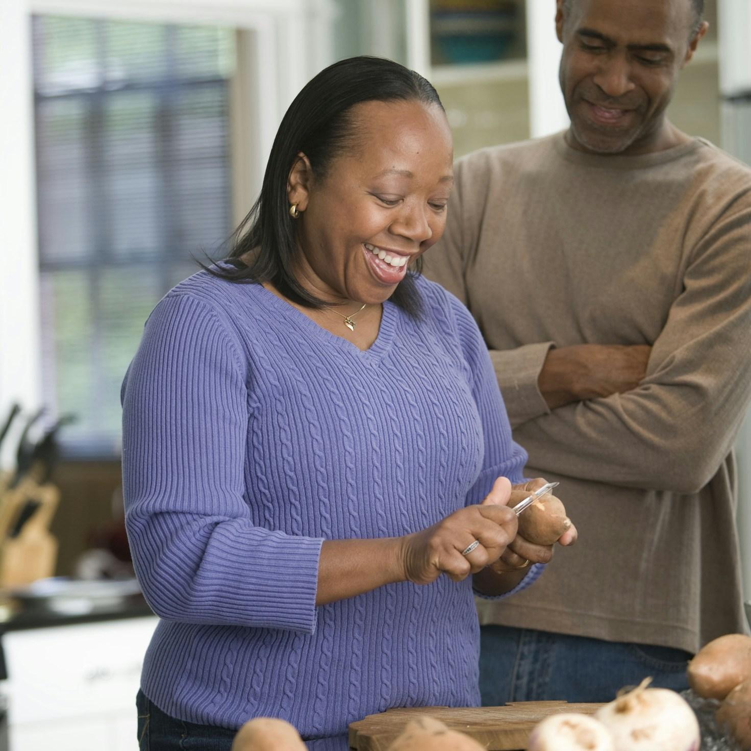 Diverse group of community members sharing a meal together, showcasing the social bonds formed through collaborative cooking